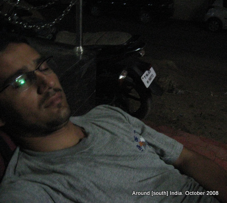dinesh wagle struggles to take a nap on the street just outside a hotel in rameswaram
