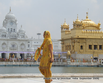 a kid runs after taking dip in the sacred pond at the golden temple, amritsar
