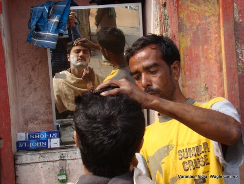 clean shave at a varanasi ghat