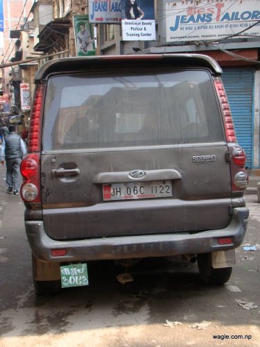 a car with indian and nepali license plates in kathmandu