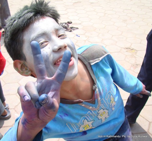 A lad celebrating Holi poses for camera in Minbhawan, Kathmandu