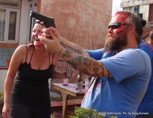 A foreign national points water gun at filmmaker Murray Kerr (not seen in the photo) while celebrating Holi at the rooftop of a hotel in Thamel, Kathmandu