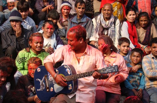 A group of locals try to have some fun in Basantapur Darbar Square in Kathmandu while celebrating Holi