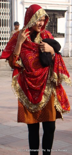 A Marwari girl looks for her friends after she performs pooja at the Cheer as part of Holi celebrations by her community