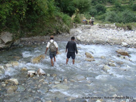 men crossing a river