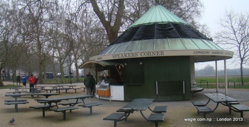 A shop near the Speakers' Corner in Hyde Park with SC on background. Empty tables await speakers and listeners.