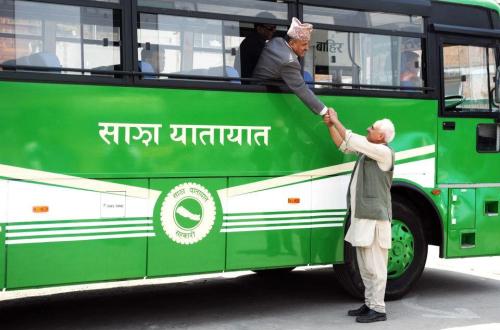 Sajha bus chairman Kanak Mani Dixit, standing, sees off chief secretary Lilamani Poudel who traveled in an inauguratory service.