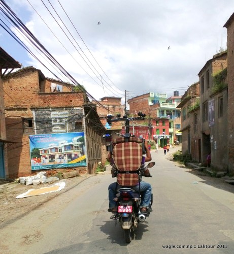 two people on a bike and a chair over their head